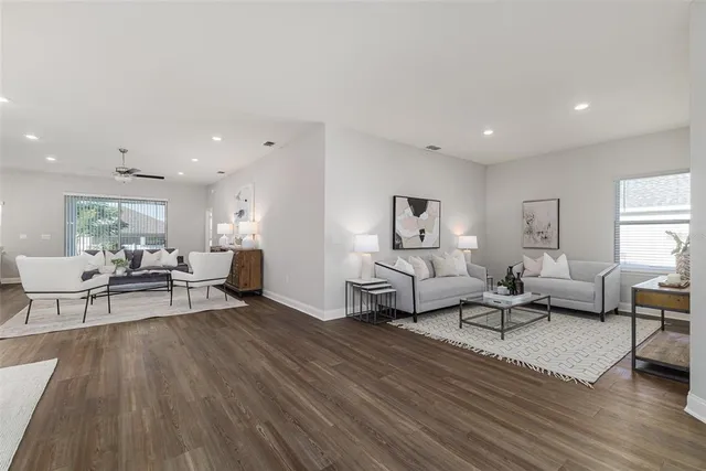 a living room with furniture and a wooden floor
