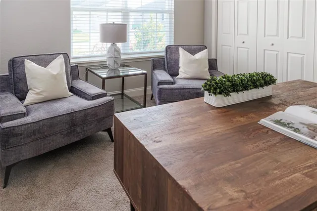 a living room with furniture and flowers