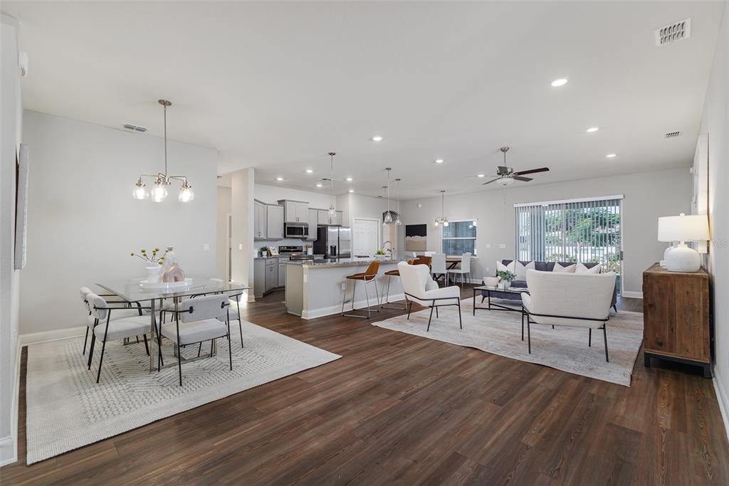 3150 Kendal Way Lakeland, FL 33813 - Photo 4 of 61 a living room with furniture dining table and wooden floor