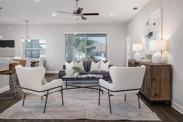 a living room with furniture and wooden floor