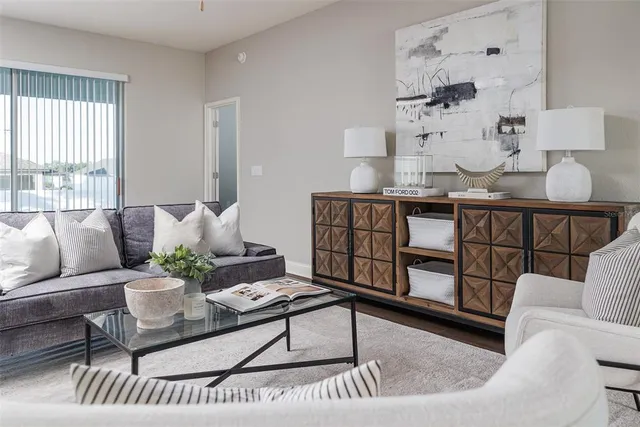 a living room with furniture and a rug