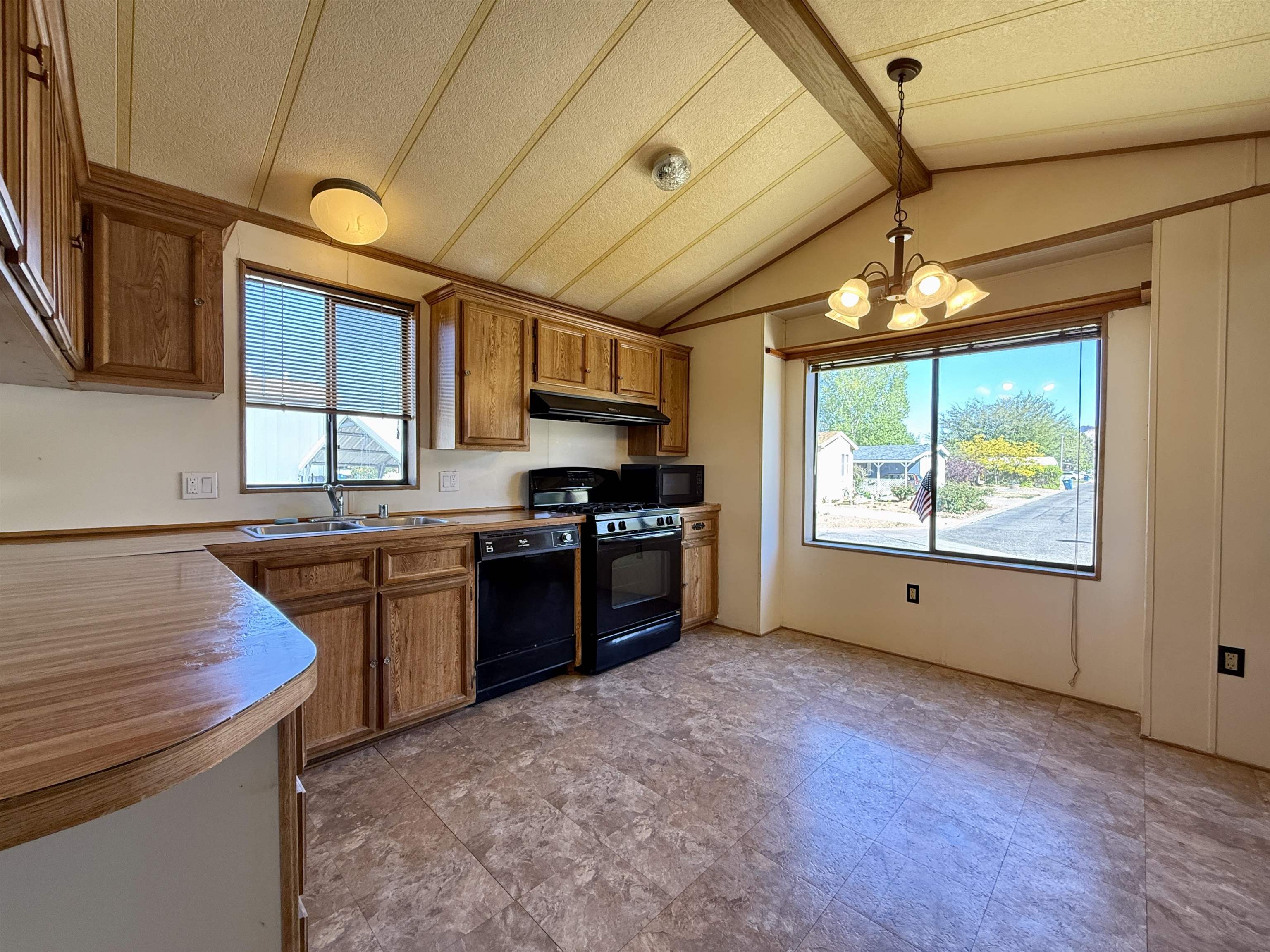 3251 E Road, Unit 33 Clifton, CO 81520 - Photo 6 of 28 a kitchen with stainless steel appliances granite countertop a stove a sink and a refrigerator