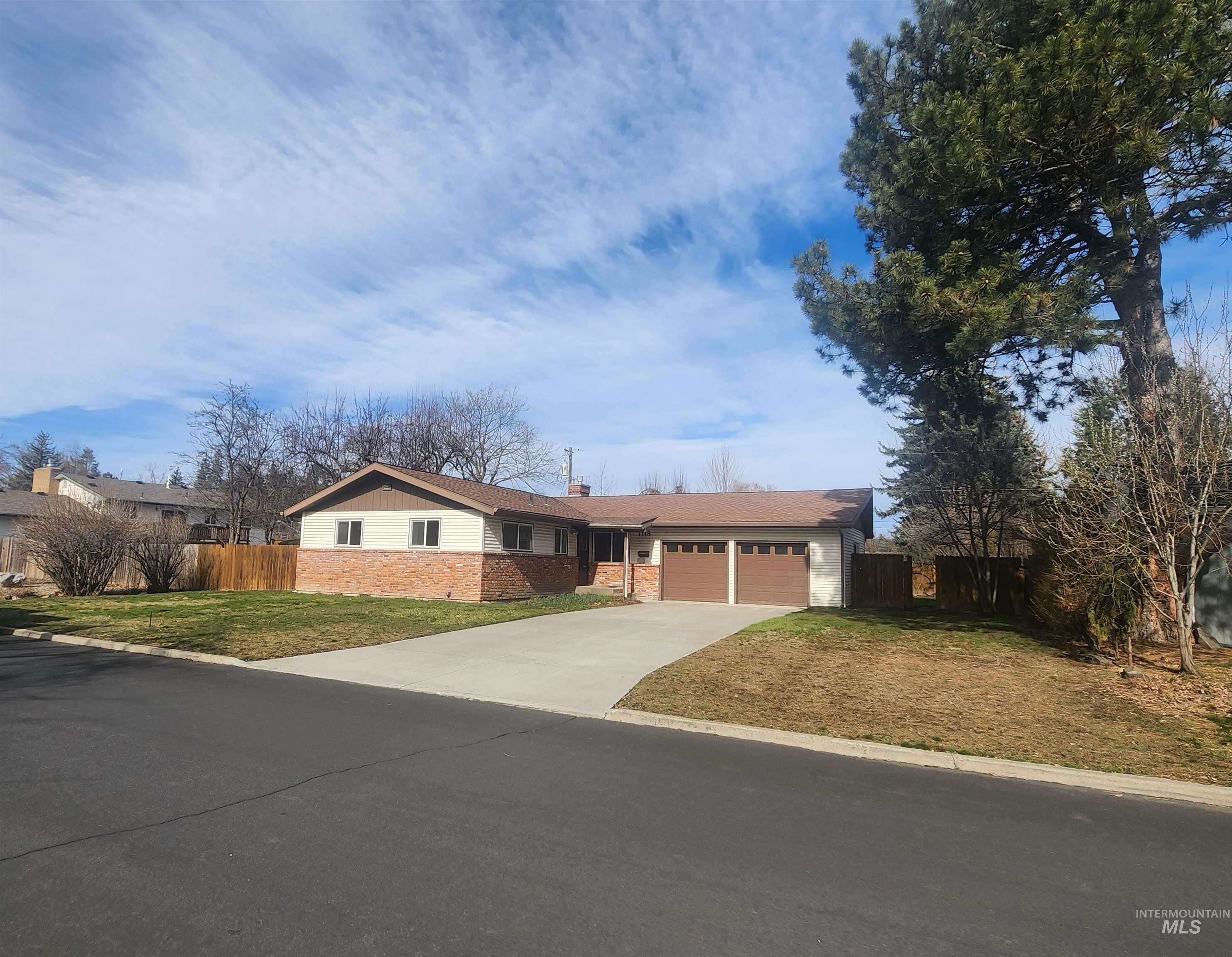 1118 Joseph Street Moscow, ID 83843 - Photo 1 of 1 Ranch-style house with an attached garage, driveway, and a chimney