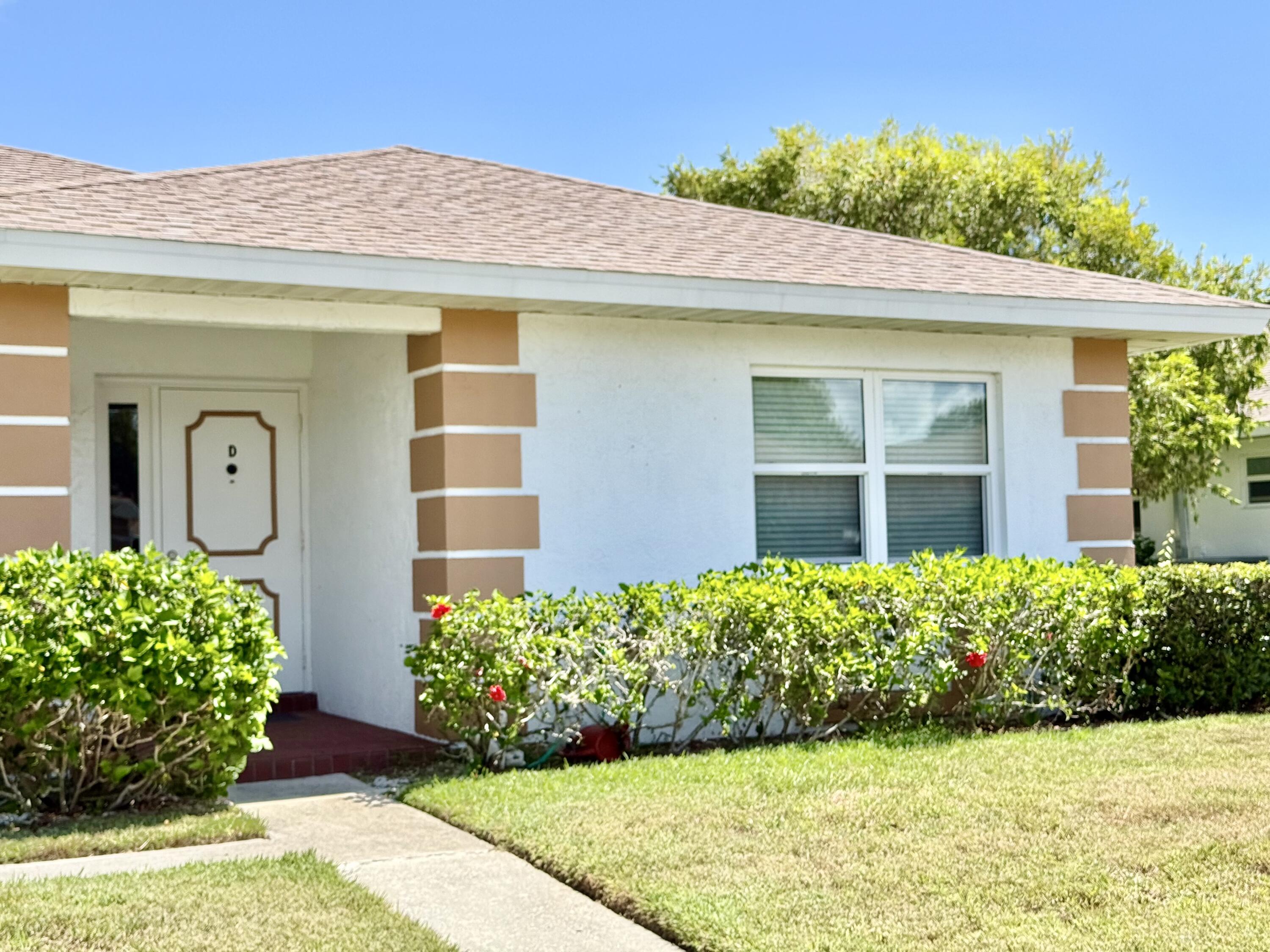 a view of a house with potted plants