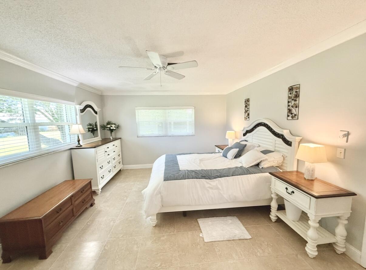 828 Timberview Drive, Unit D Fort Pierce, FL 34982 - Photo 13 of 28 a bed room with a bed and a window