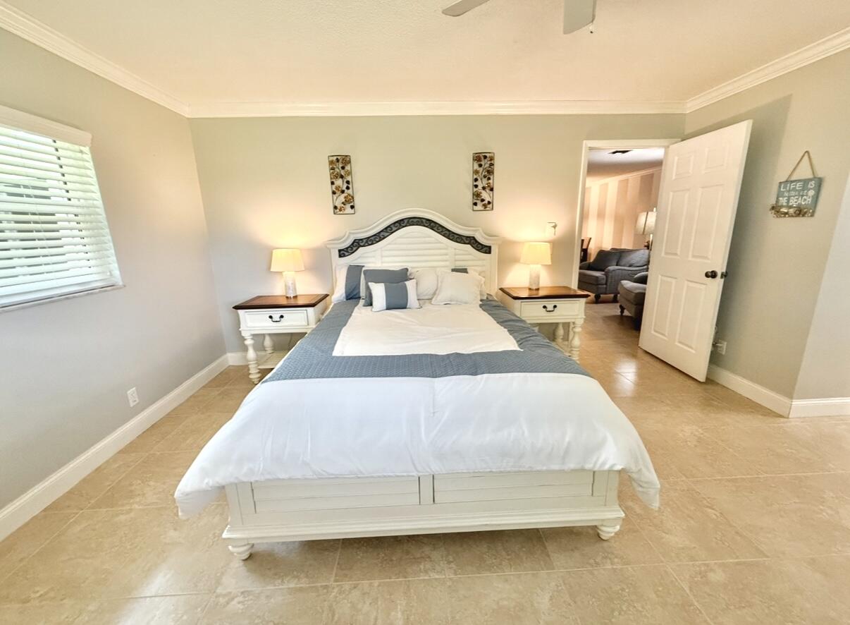 828 Timberview Drive, Unit D Fort Pierce, FL 34982 - Photo 14 of 28 a spacious bedroom with a bed and wooden floor