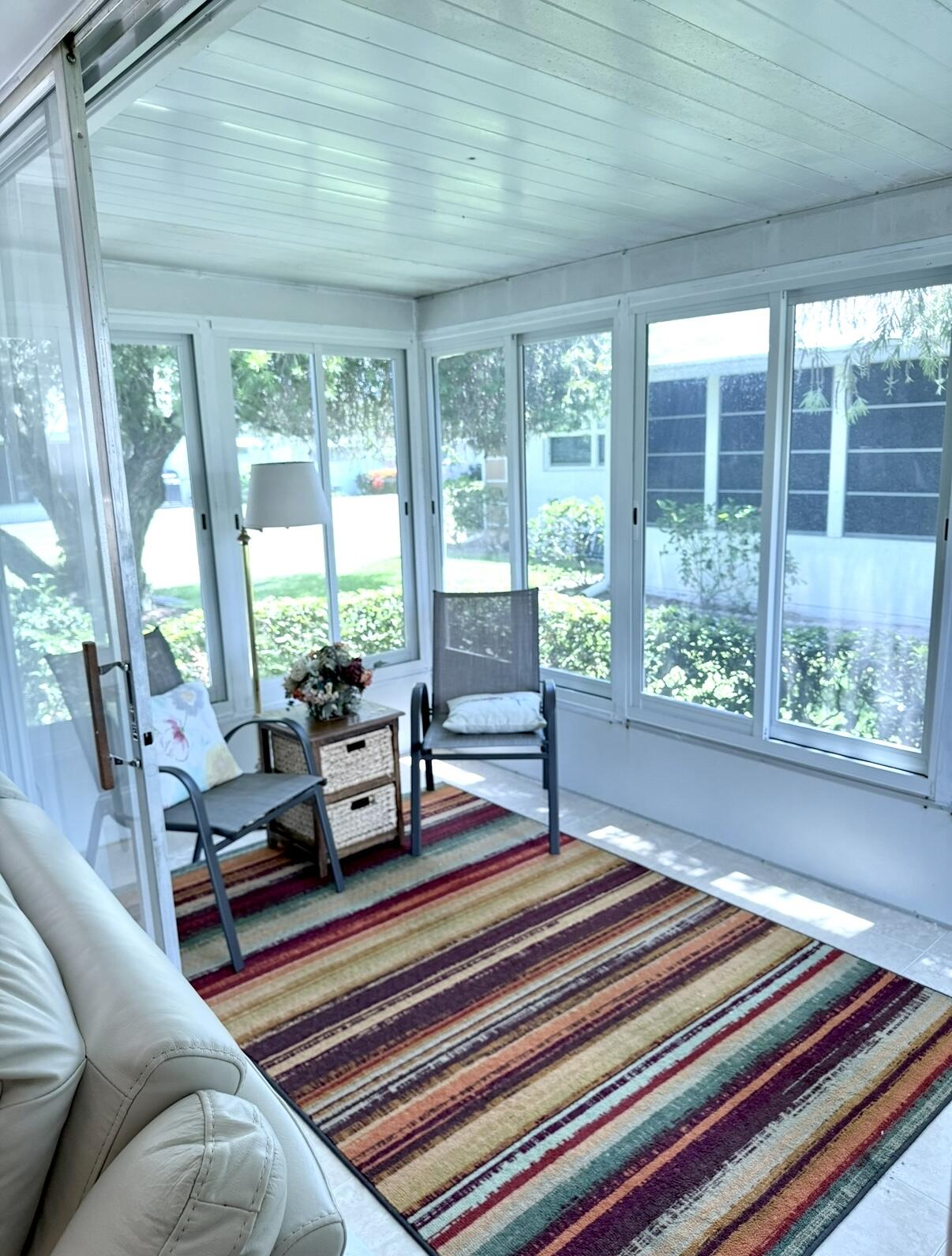 828 Timberview Drive, Unit D Fort Pierce, FL 34982 - Photo 21 of 28 a living room with furniture and a floor to ceiling window