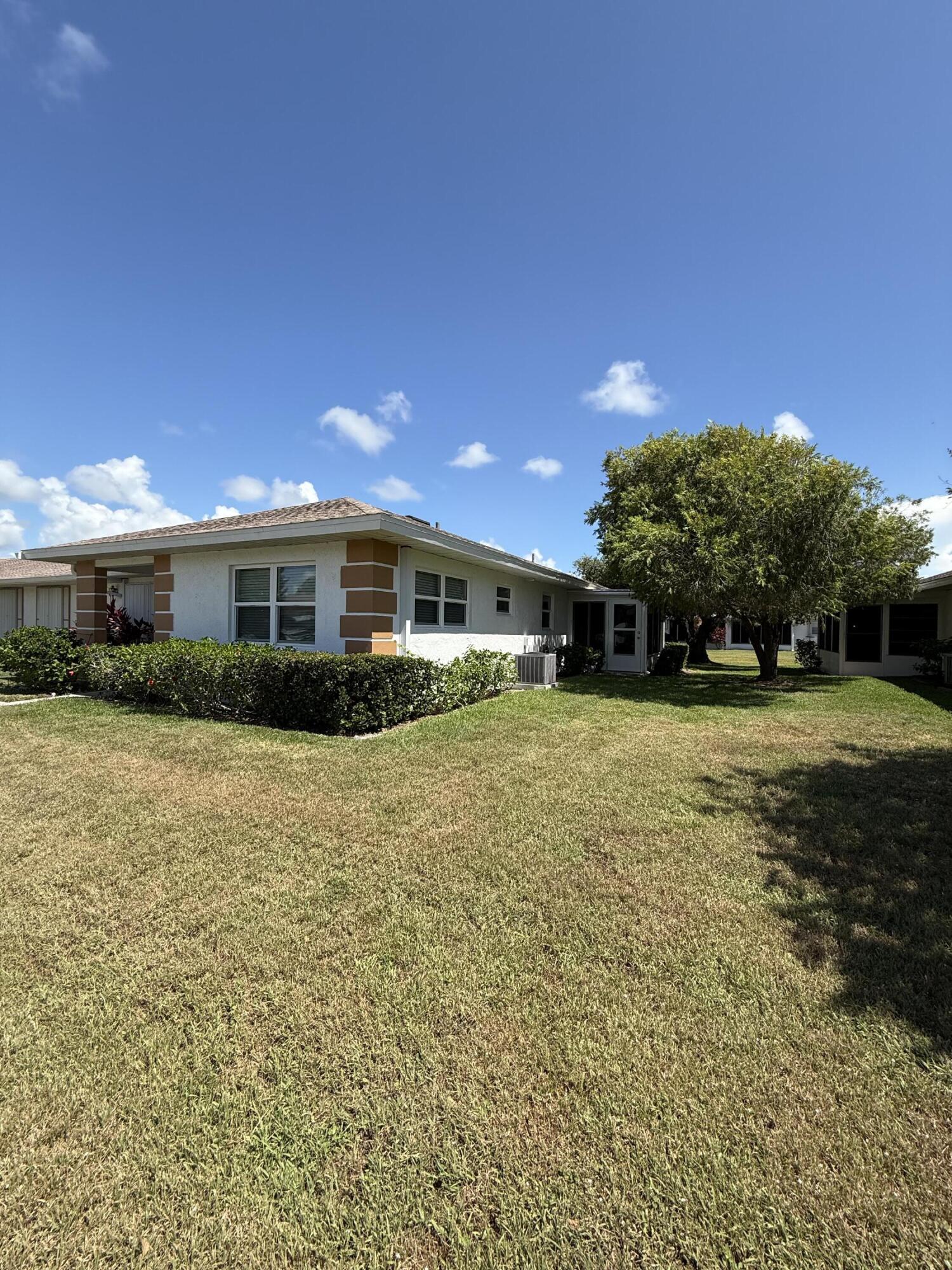 828 Timberview Drive, Unit D Fort Pierce, FL 34982 - Photo 22 of 28 a front view of a house with a yard