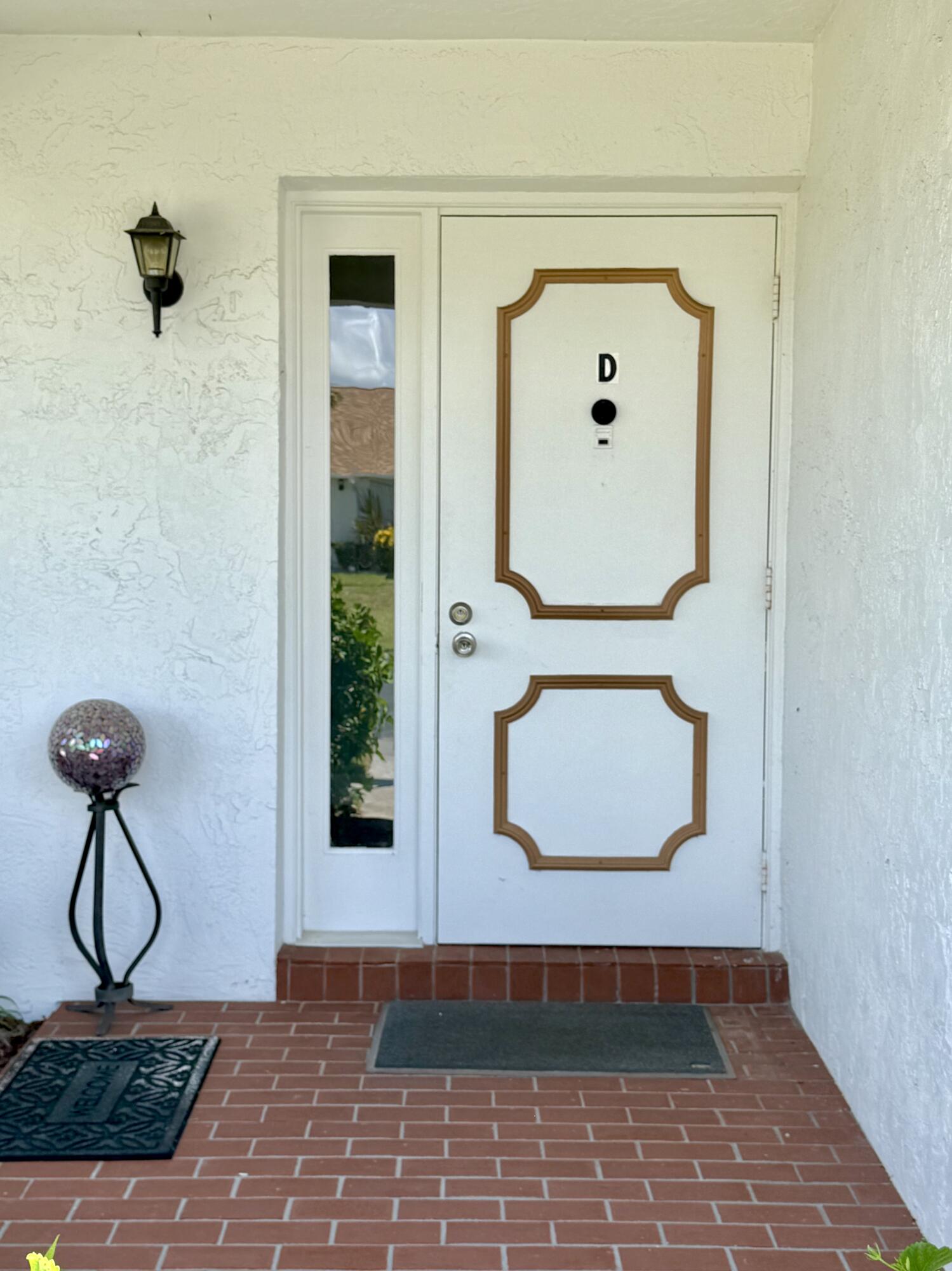 828 Timberview Drive, Unit D Fort Pierce, FL 34982 - Photo 3 of 28 a view of a hallway with wooden floor and a potted plant