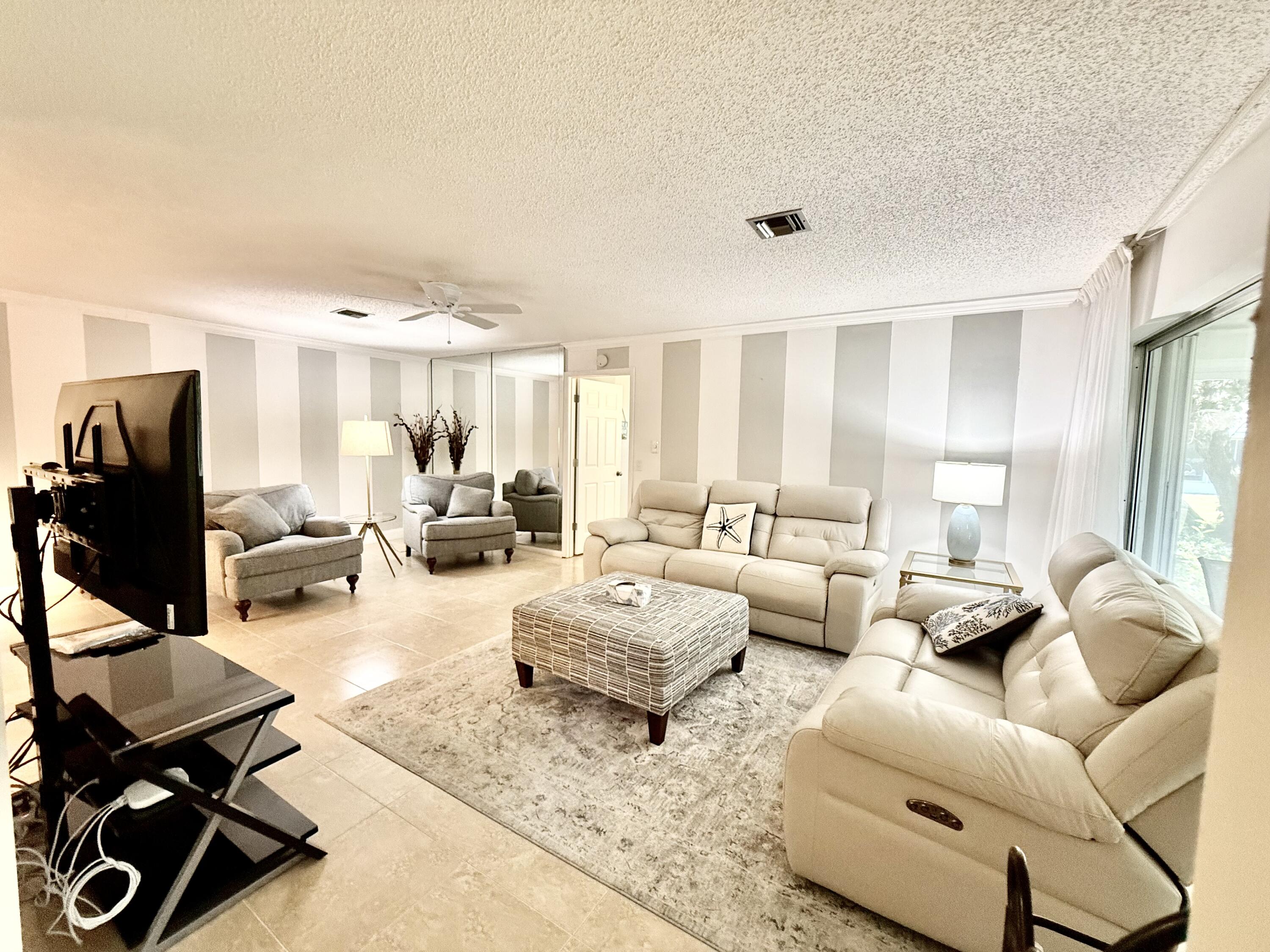 828 Timberview Drive, Unit D Fort Pierce, FL 34982 - Photo 7 of 28 a living room with furniture and wooden floor