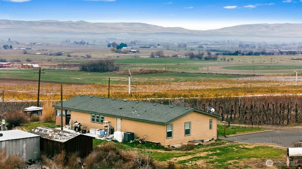 a view of a house with a yard and ocean view