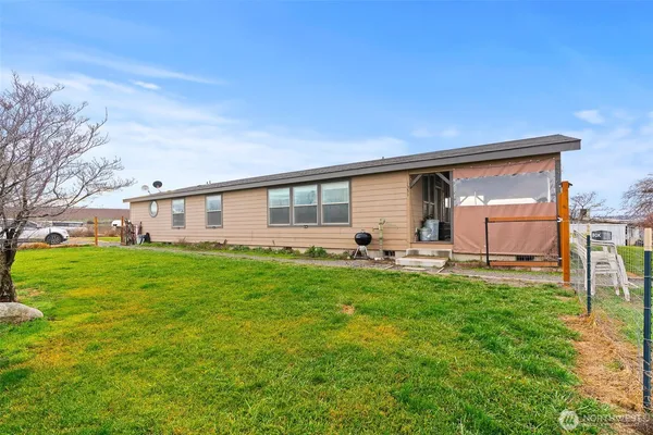 a backyard of a house with table and chairs