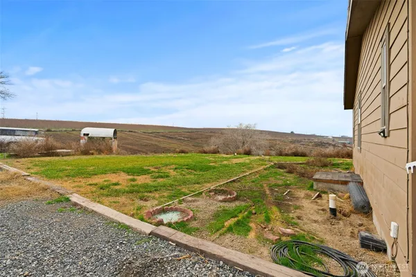 a view of a field with an ocean view
