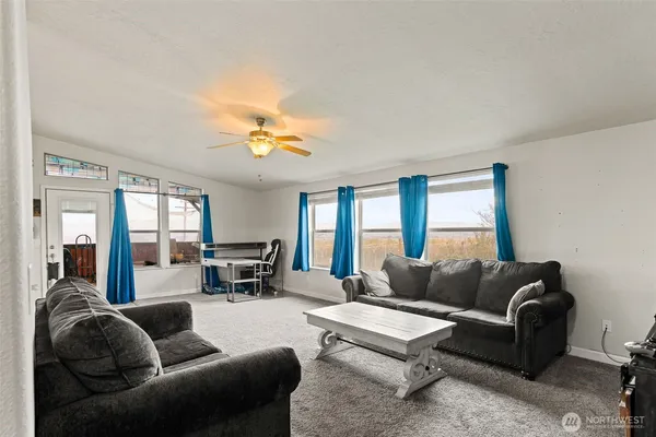 a living room with furniture and a large window