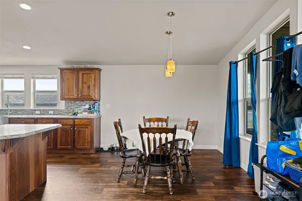 a view of a dining room with furniture and a window