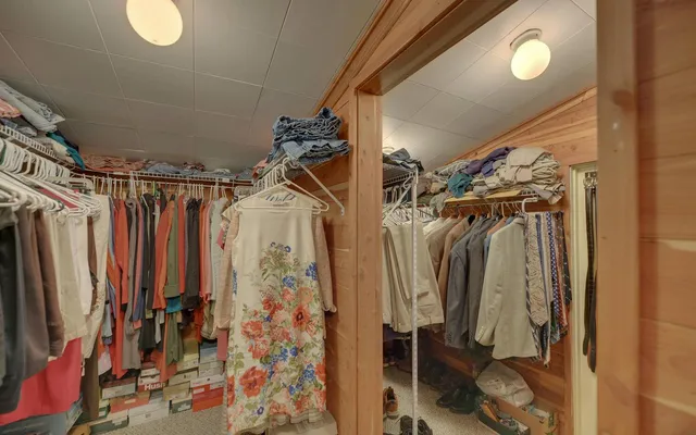 a view of walk in closet with clothes