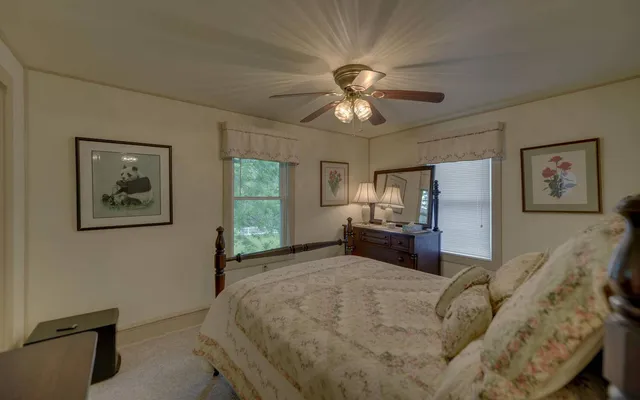 a spacious bedroom with a bed and a chandelier
