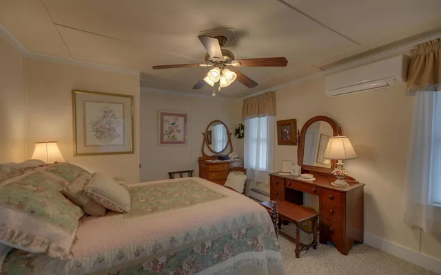 a bedroom with bed and a chandelier