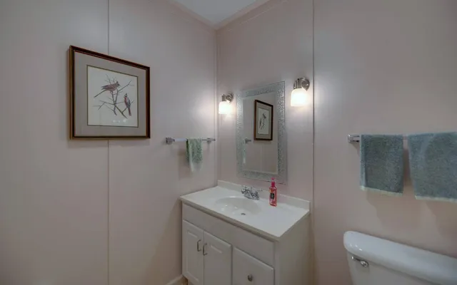 a bathroom with a toilet sink and mirror