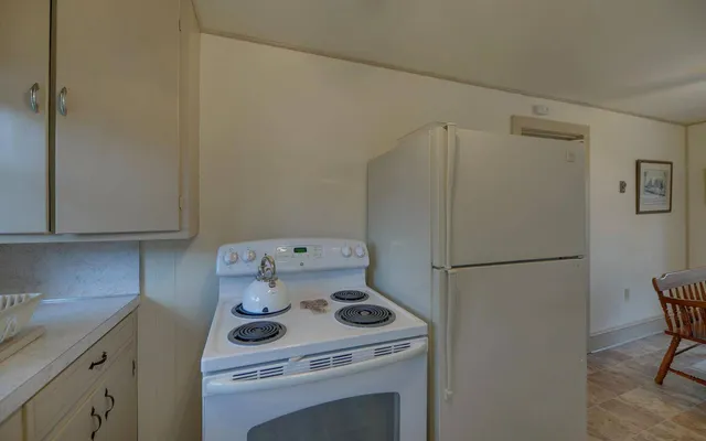a white refrigerator freezer sitting inside of a kitchen