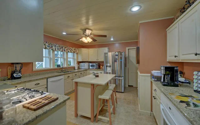 a kitchen with a sink appliances and cabinets