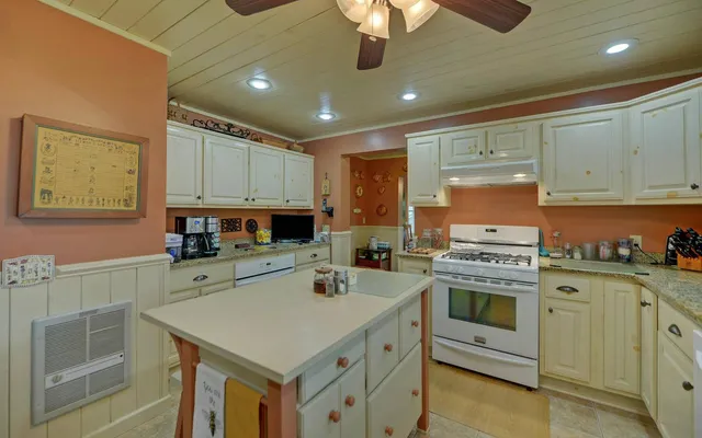 a kitchen with a stove sink and cabinets