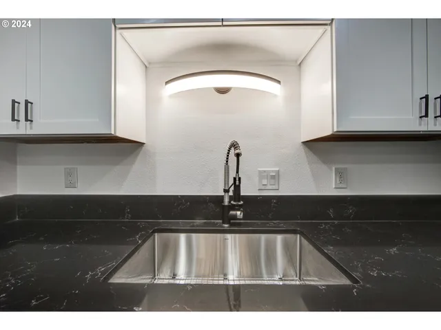 a kitchen with a sink and cabinets