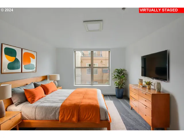 a bedroom with a bed and a flat screen tv