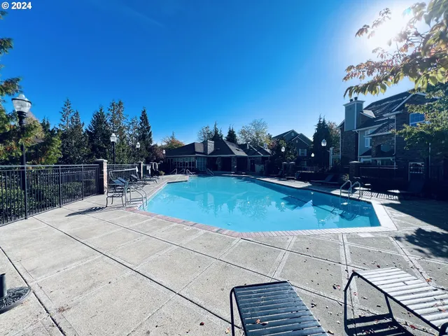 a living room with furniture a large window and a fireplace