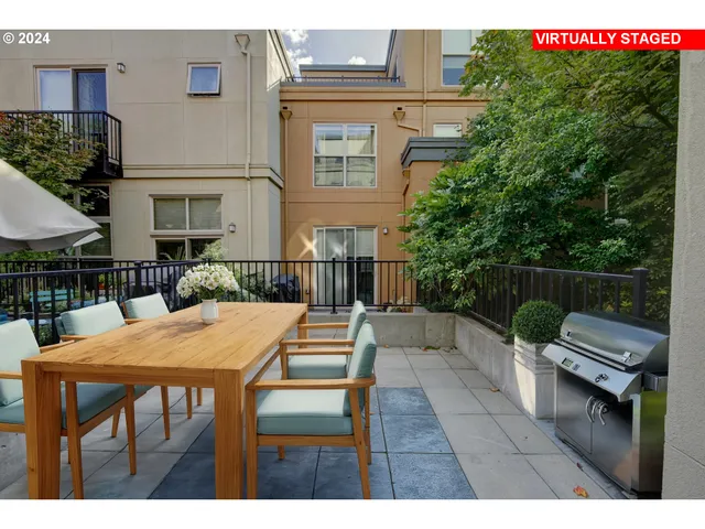 a view of a patio with a table and chairs