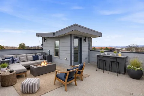 a view of a patio with couches chairs and potted plants