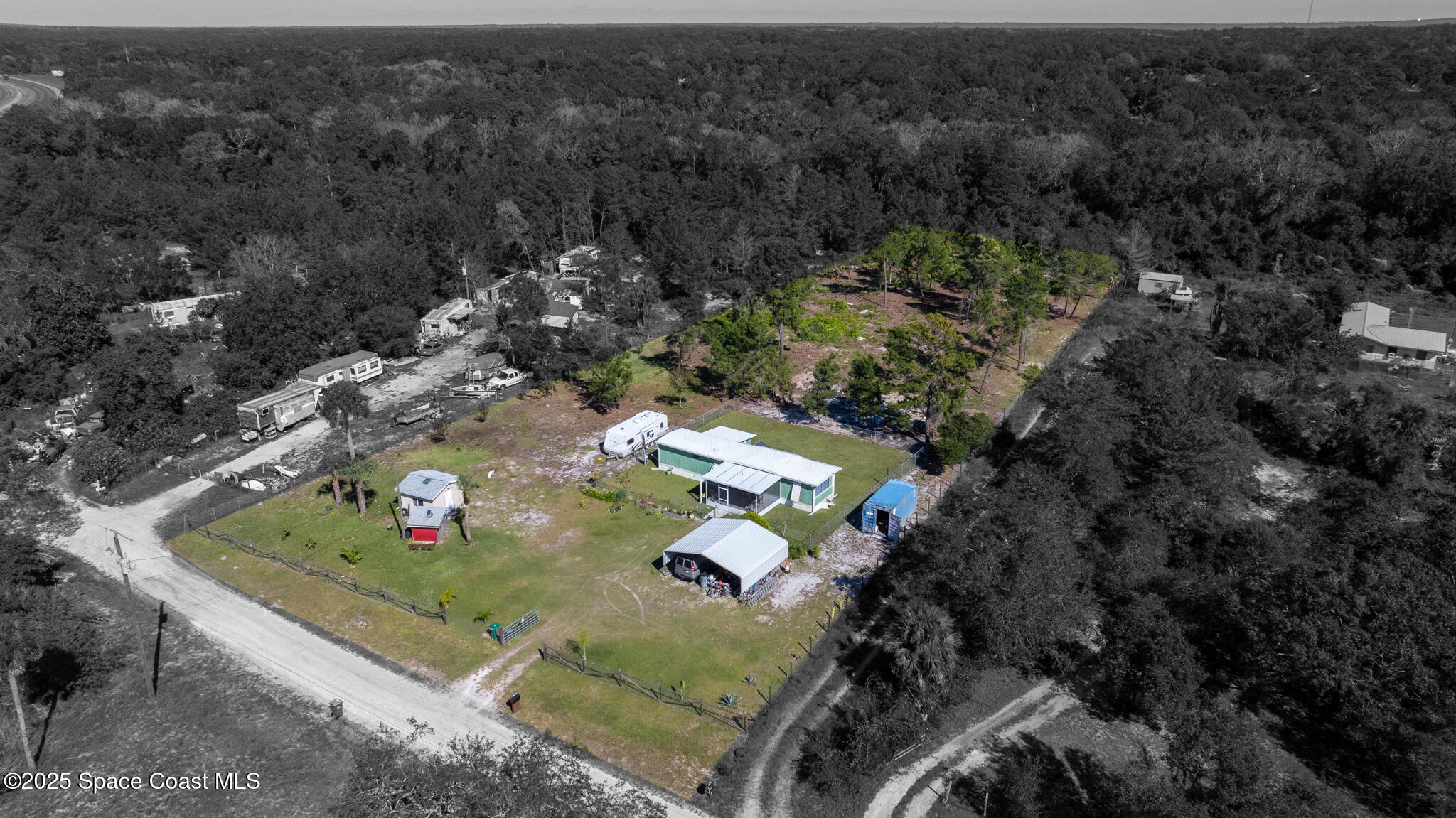 an aerial view of a house with a yard