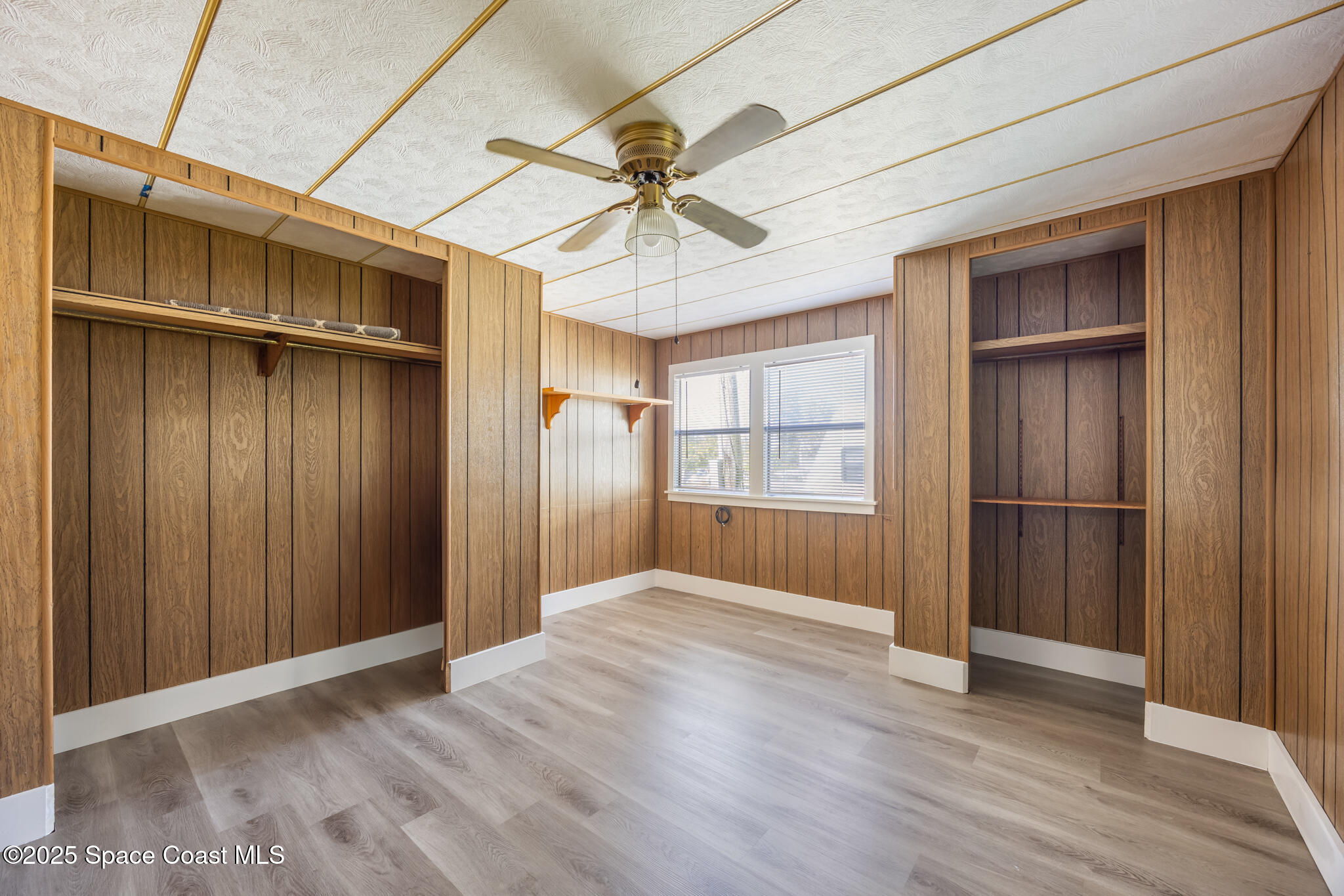4895 Orange Street Mims, FL 32754 - Photo 13 of 33 a view of empty room with wooden floor and fan