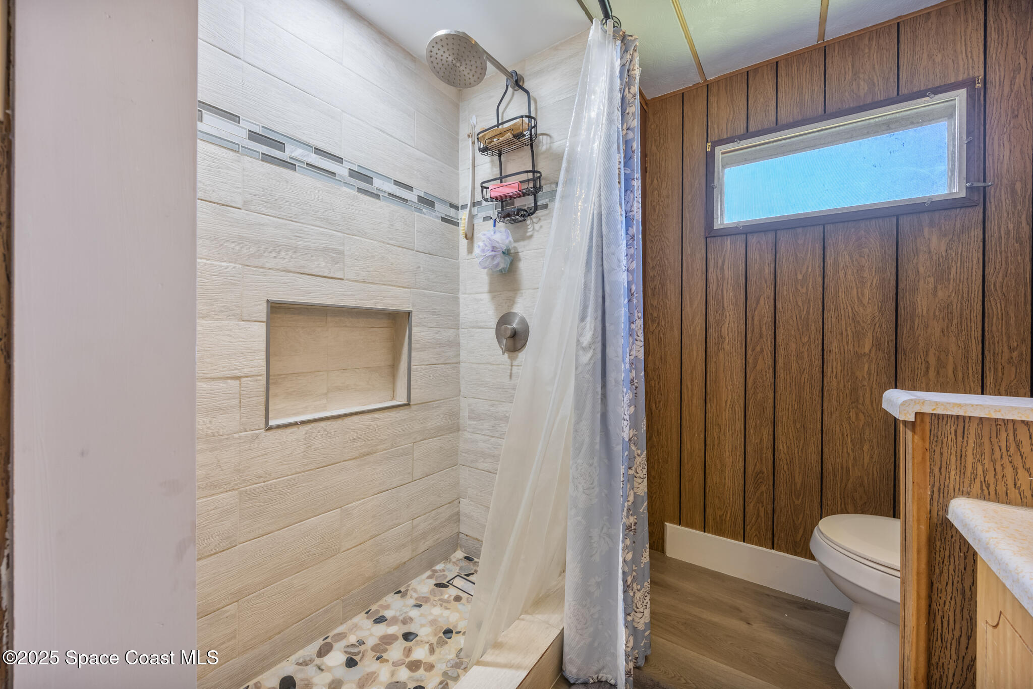 4895 Orange Street Mims, FL 32754 - Photo 18 of 33 a bathroom with a toilet and shower