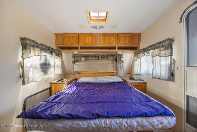 a bed sitting in a bedroom next to a window