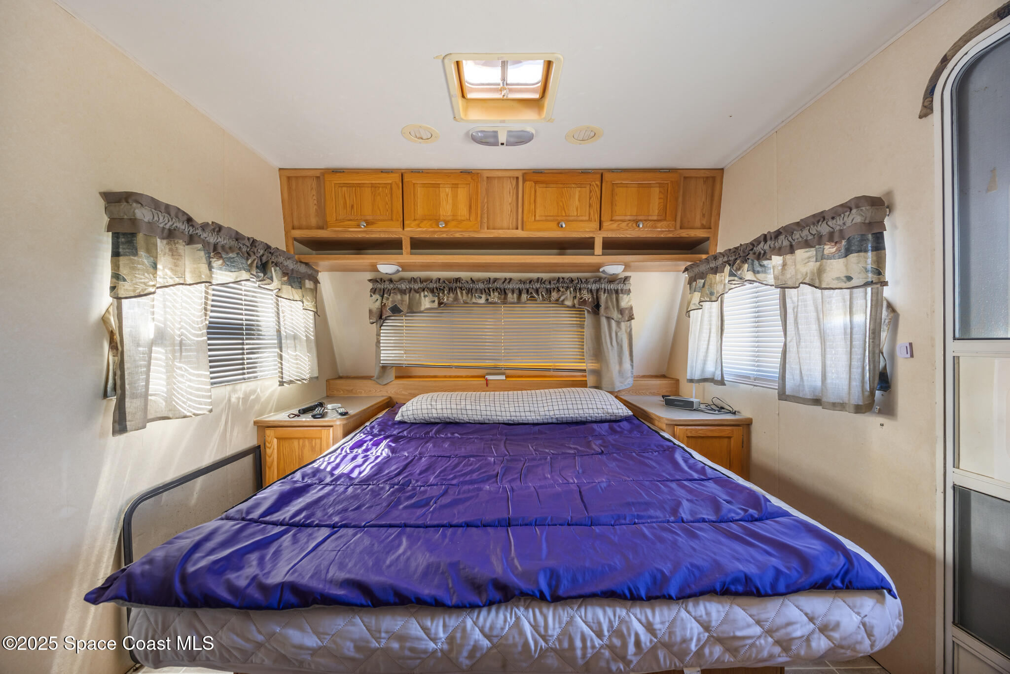 4895 Orange Street Mims, FL 32754 - Photo 24 of 33 a bed sitting in a bedroom next to a window