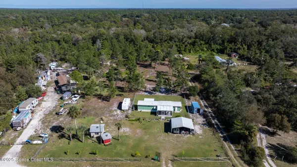 an aerial view of a house with a yard