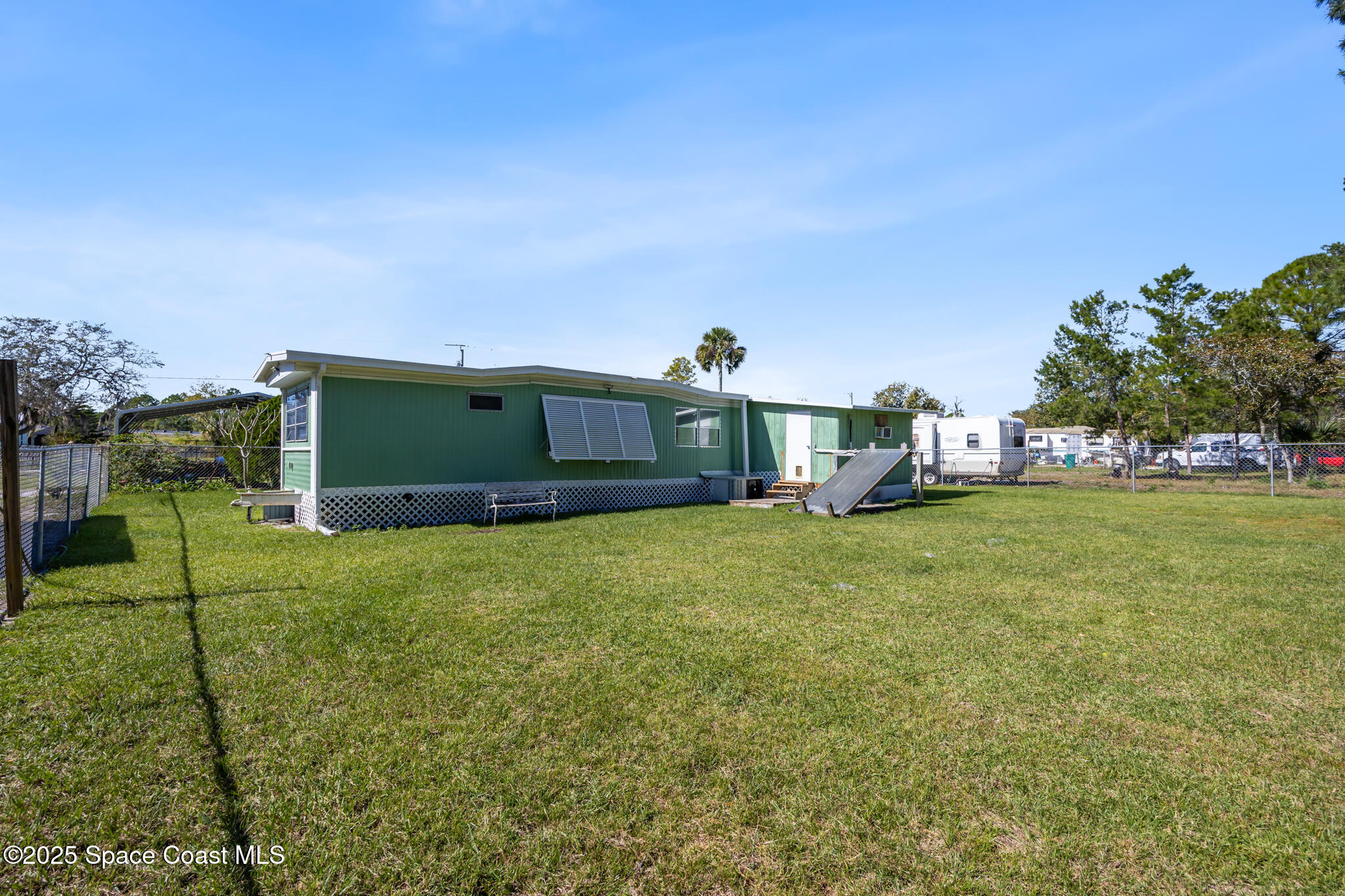 4895 Orange Street Mims, FL 32754 - Photo 5 of 33 a front view of a house with a yard