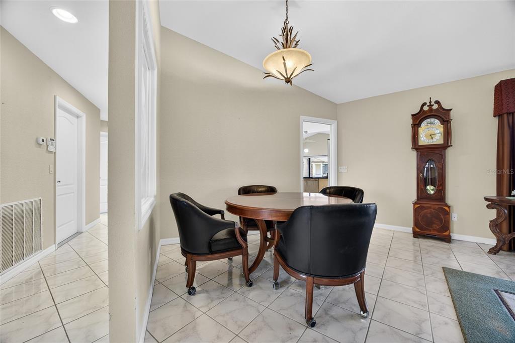 4075 Turtle Dove Circle Punta Gorda, FL 33950 - Photo 18 of 43 a view of a dining room with furniture and chandelier