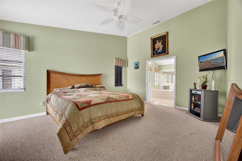 4075 Turtle Dove Circle Punta Gorda, FL 33950 - Photo 19 of 43 a bedroom with a bed and a flat screen tv