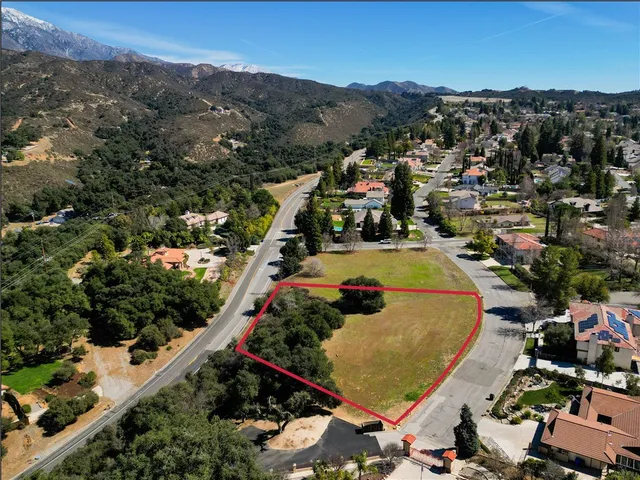 an aerial view of a swimming pool and mountain view in back