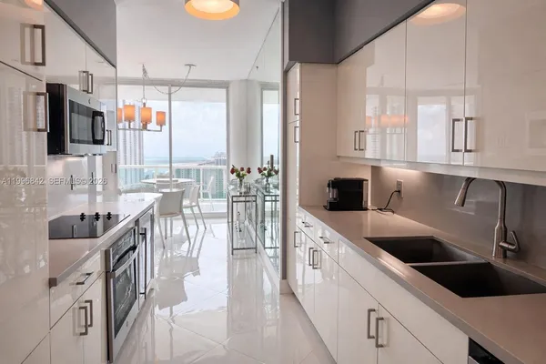 a kitchen with stainless steel appliances a sink and a refrigerator