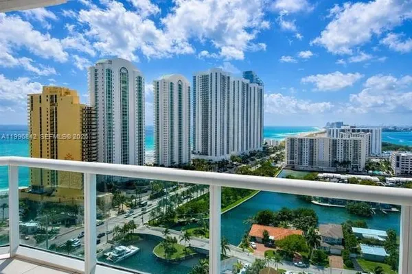 a view of a balcony with yard