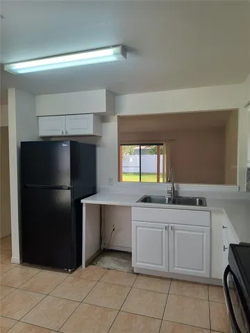 a kitchen with stainless steel appliances a sink and a refrigerator