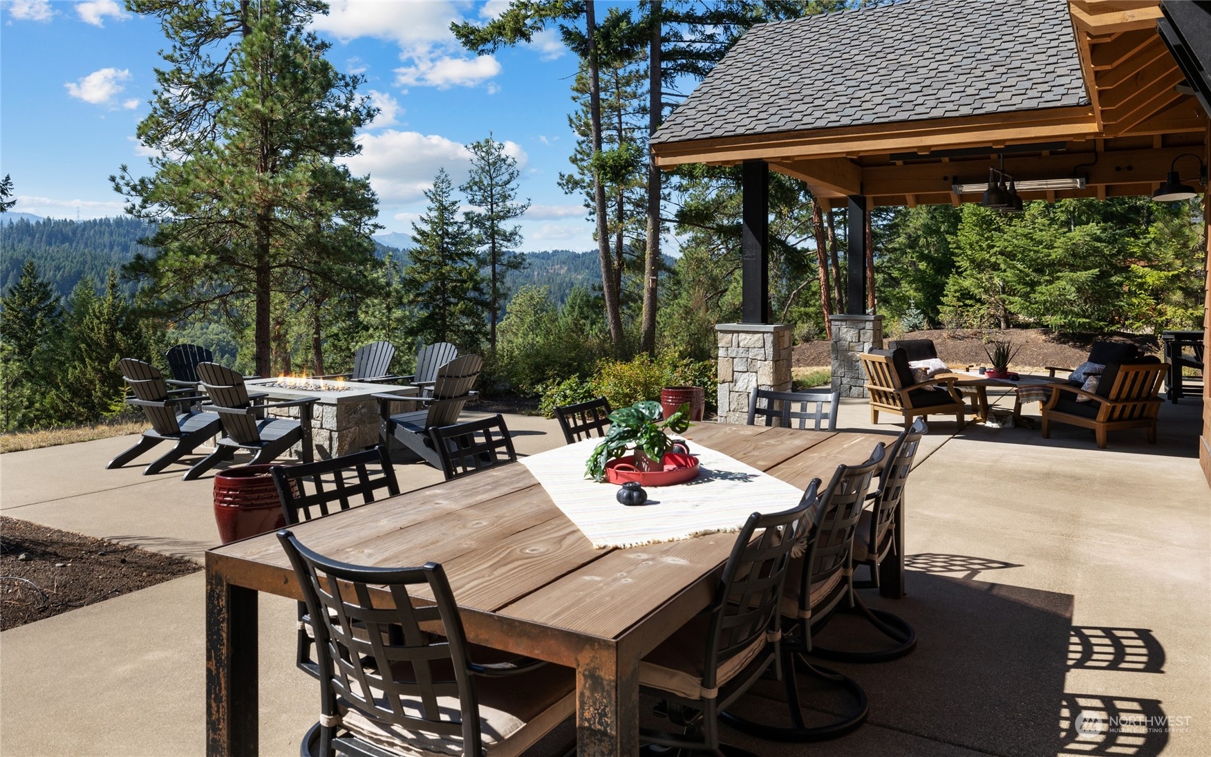 1040 Pinegrass Loop Cle Elum, WA 98922 - Photo 14 of 39 a view of a patio with table and chairs and potted plants