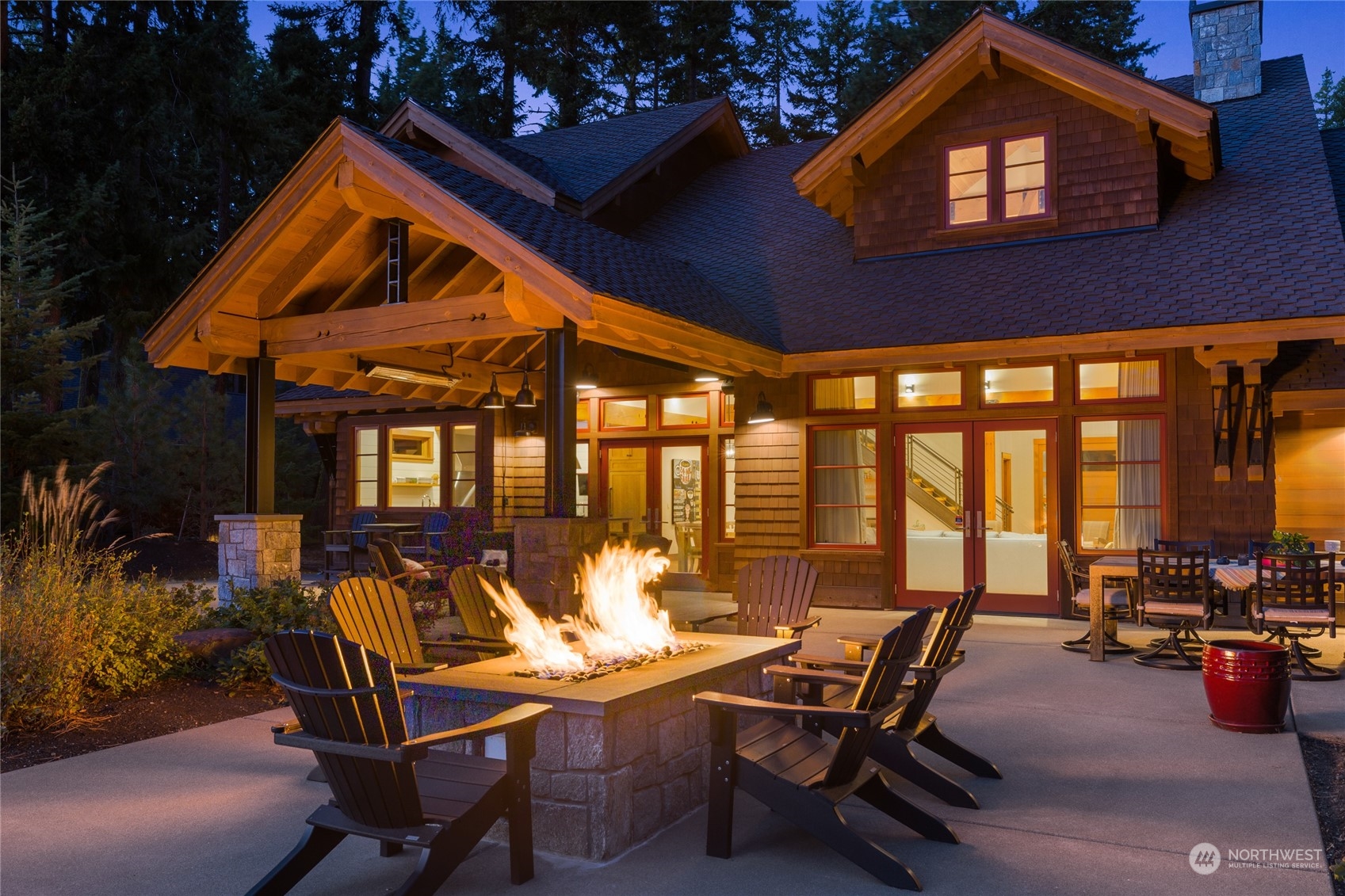 1040 Pinegrass Loop Cle Elum, WA 98922 - Photo 16 of 39 a view of a patio with a dining table and chairs with a fire pit