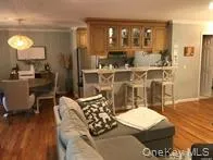 a kitchen with stainless steel appliances granite countertop a table chairs stove a sink and a refrigerator