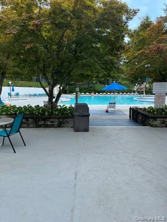 a view of chairs and table in patio with a fire pit