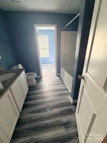 a view of bedroom and wooden floor