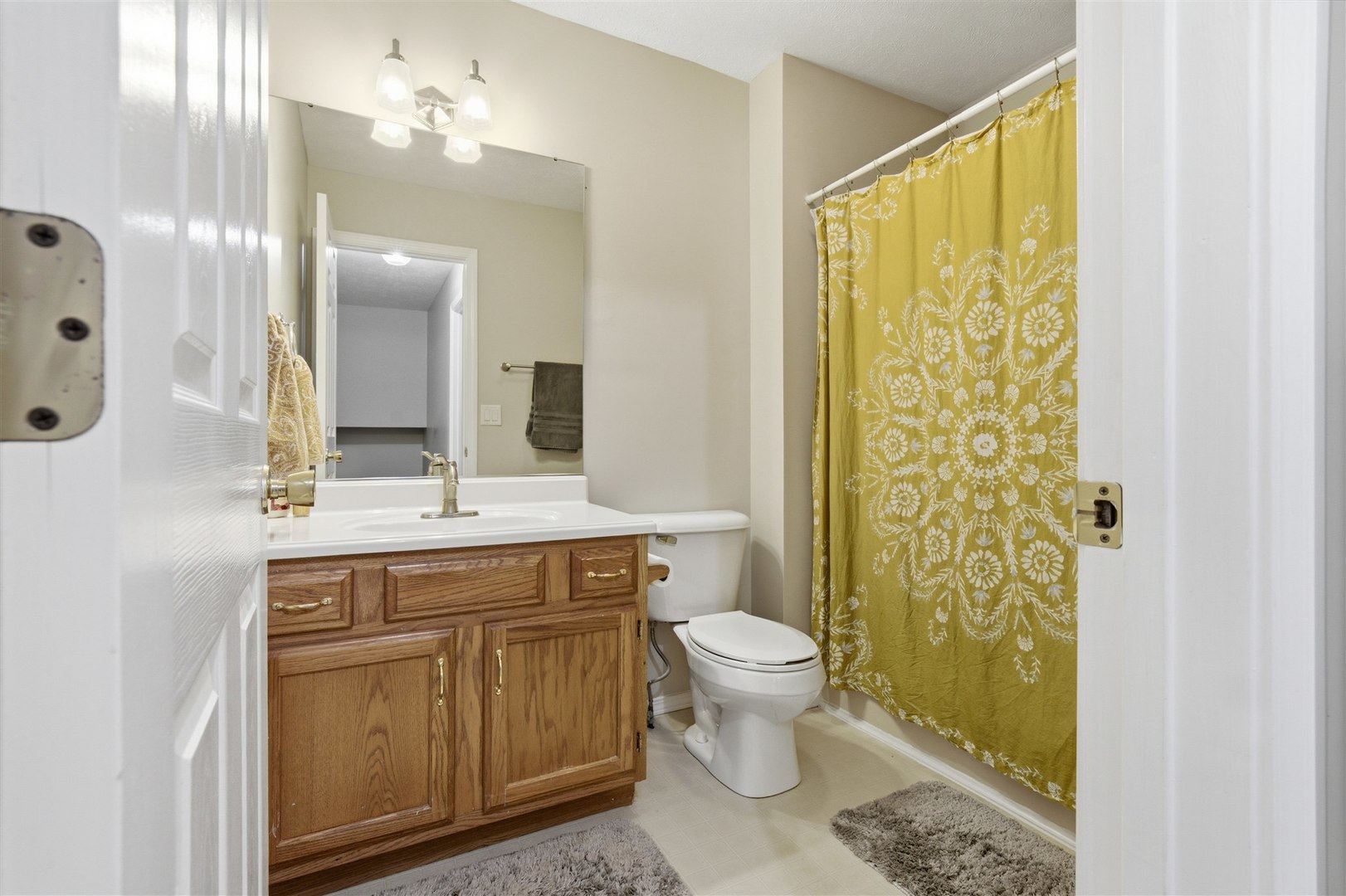811 Landau Lane Normal, IL 61761 - Photo 14 of 34 a spacious bathroom with a granite countertop sink toilet a mirror and shower